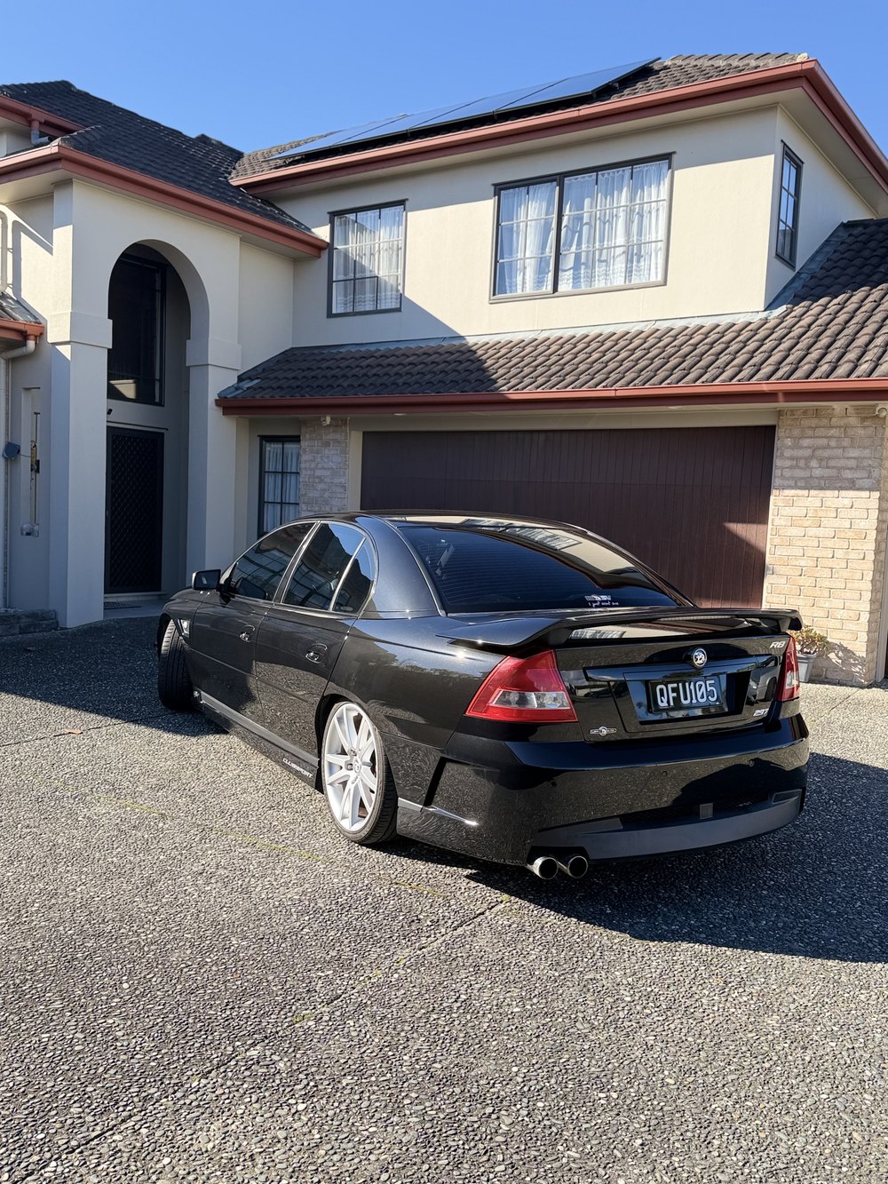 Black Holden Commodore rear view, glossy finish