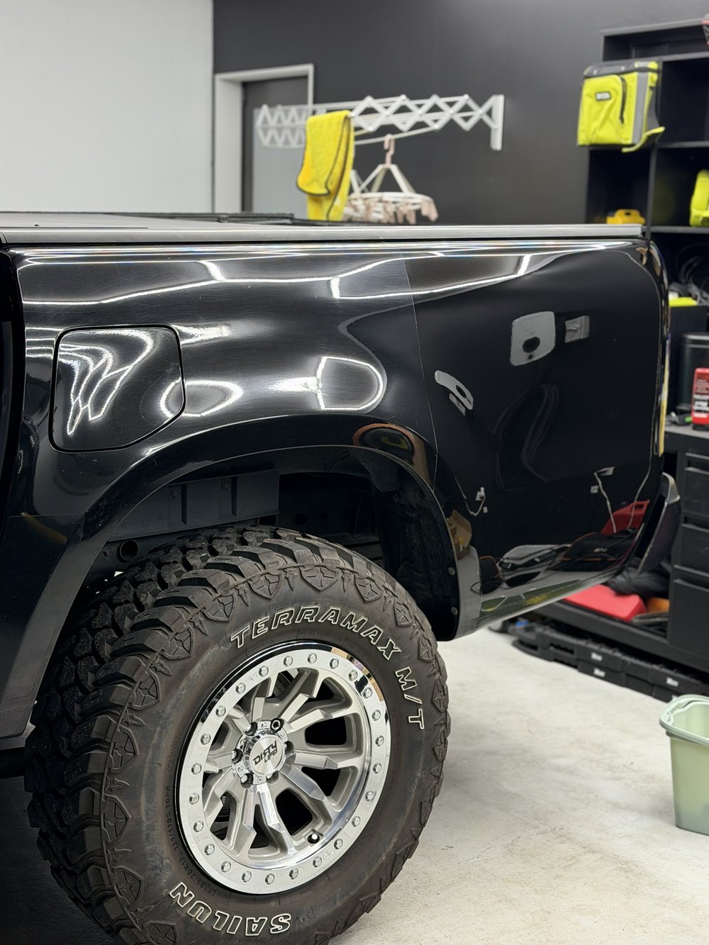 Close detail of glossy black paintwork on a Mercedes-Benz X-Class